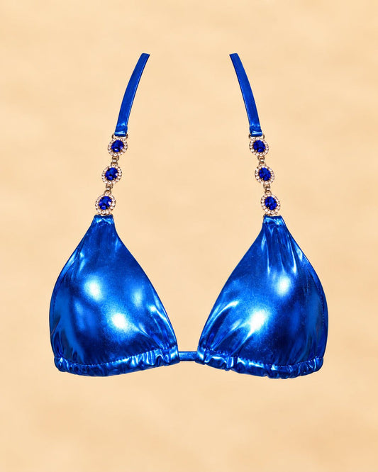 Sapphire metallic blue bikini top with jeweled straps on sandy portrait background